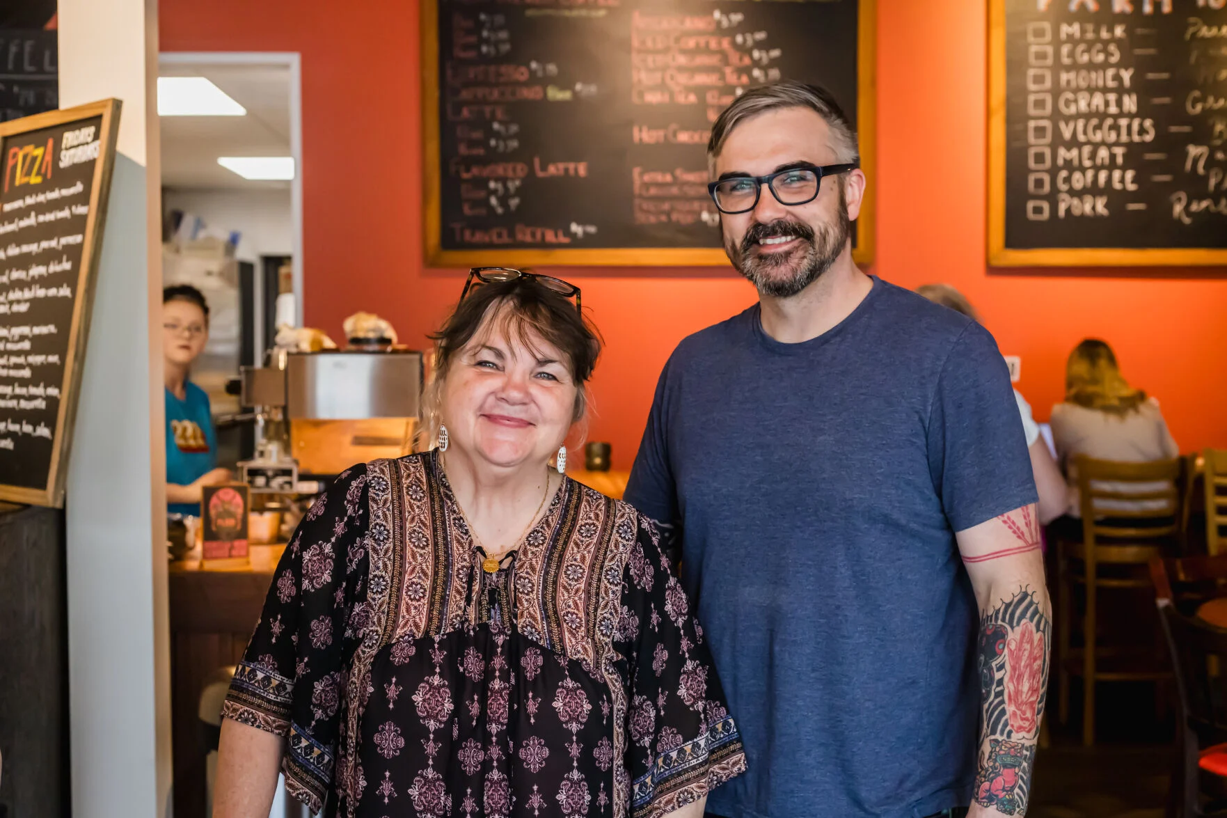 Goodner and Trevor Taynor, mother and son co-owners of Plaid Coffee Roasters, standing together inside the 222 Artisan Bakery cafe